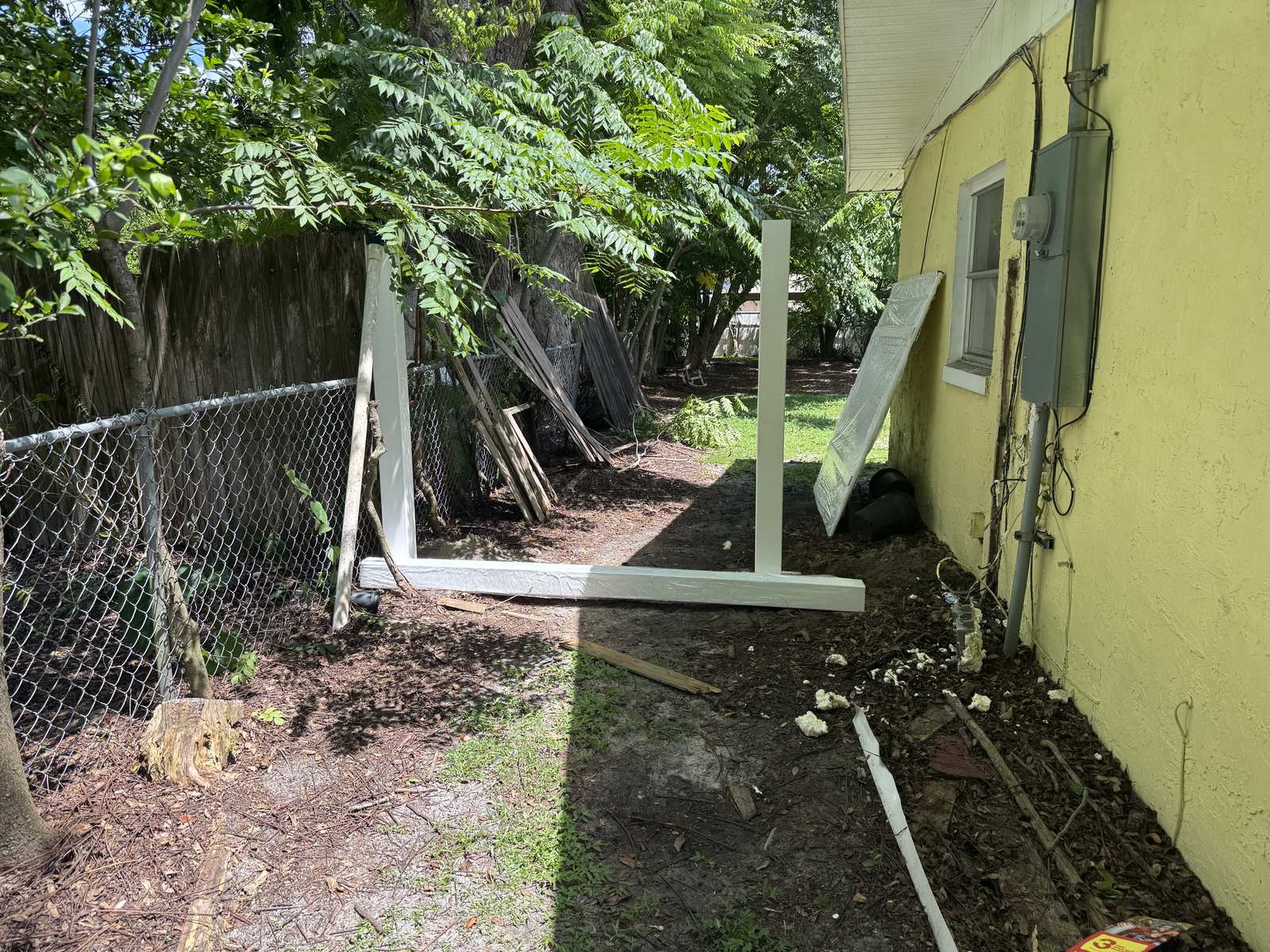 Vinyl fence posts set in concrete with the first rail installed