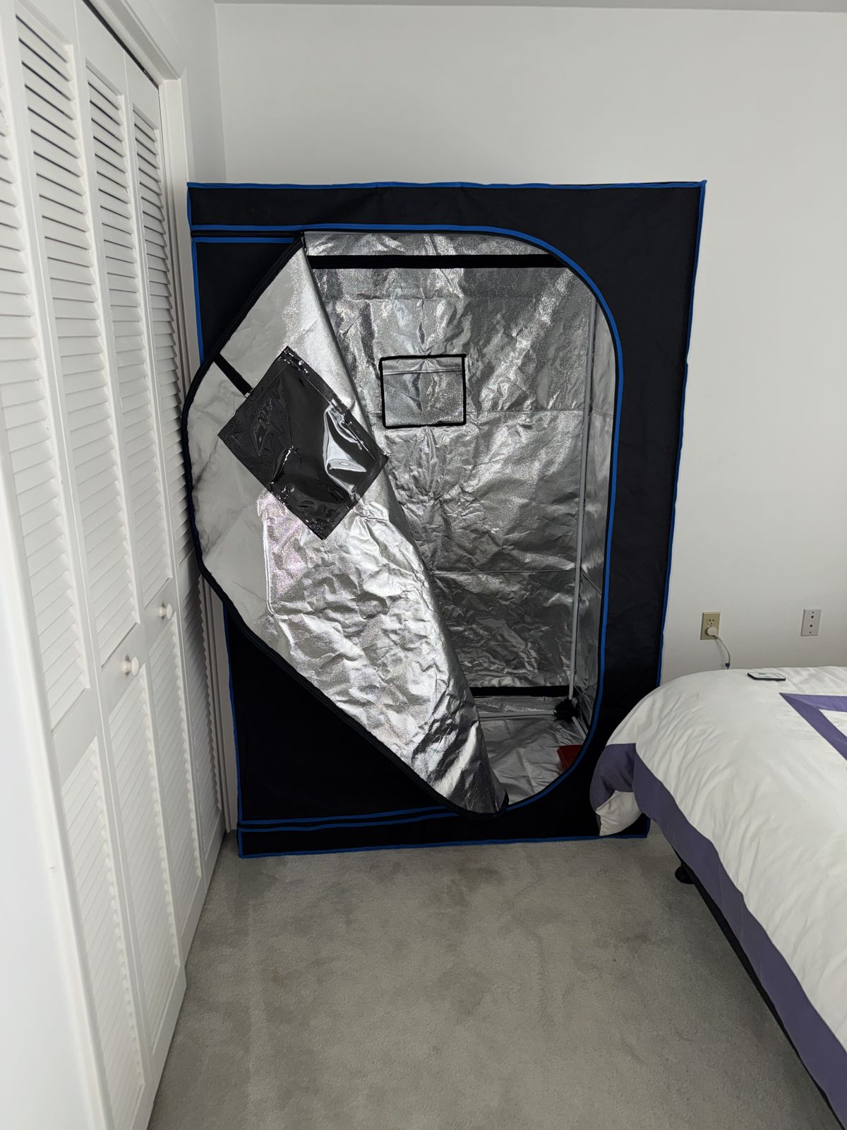 Grow tent assembled and standing in a bedroom